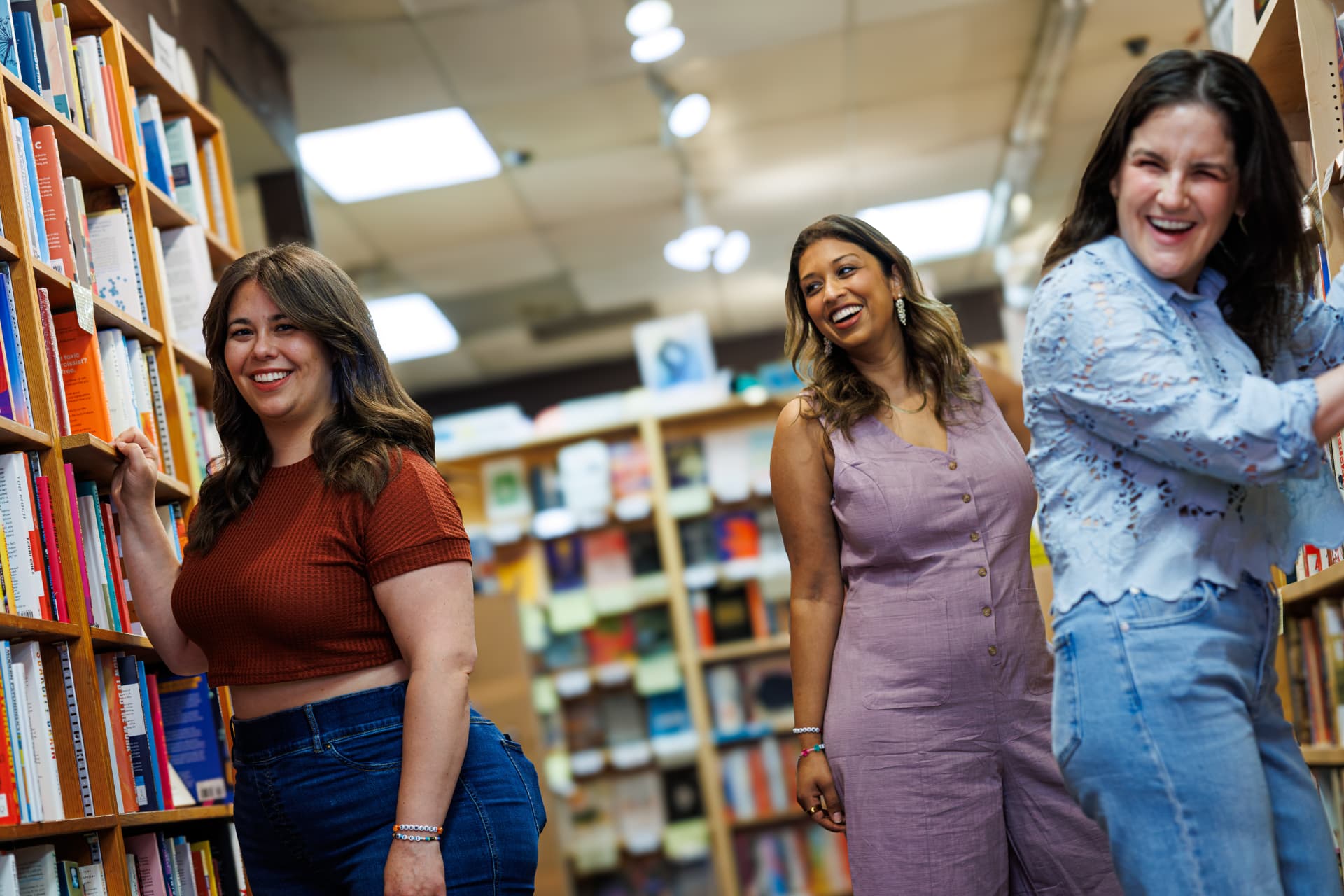 Jenn, Maansi, and Jodi browsing the bookstore shelves